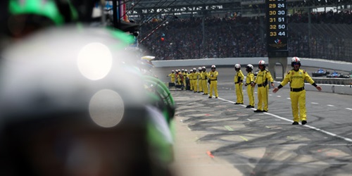 INDYCAR Officials line pit road at the Indianapolis Motor Speedway