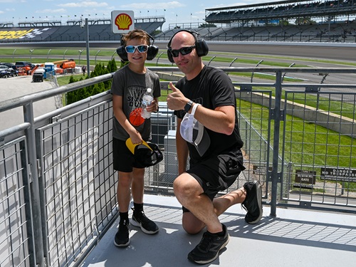 A father and son pose in the grandstand