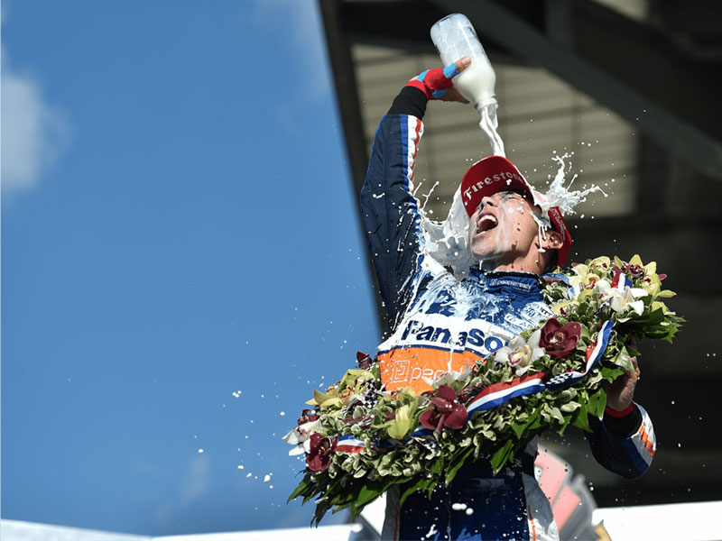 Takuma Sato enjoys milk in victory lane