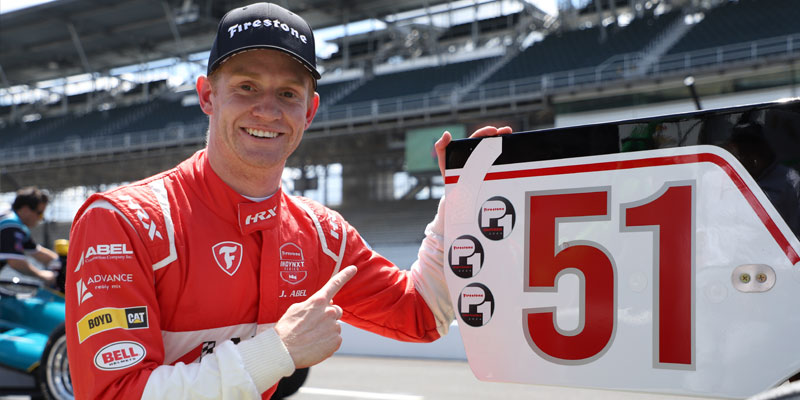 Jacob Abel points to his P1 award on the rear wing of the 51 car