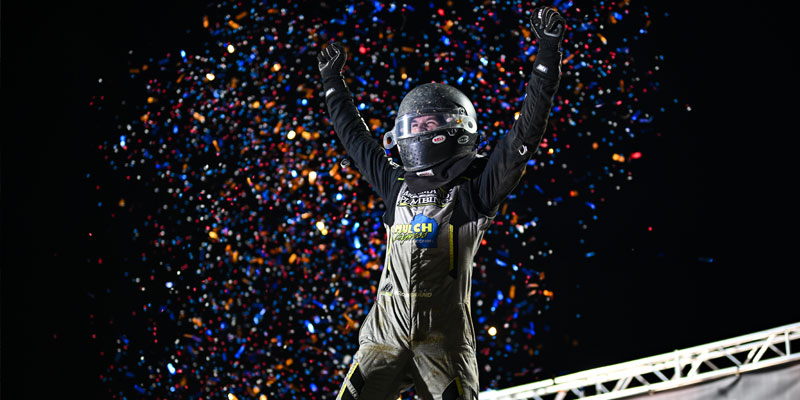 Chase McDermand celebrates with hands raised after victory on Night One at Indianapolis Motor Speedway